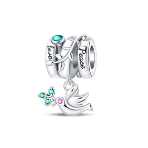 Macro detail of silver peace dove charm with green olive branch and engraved love message