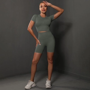 Close-up of olive green seamless yoga set featuring tight short sleeves and high waist shorts