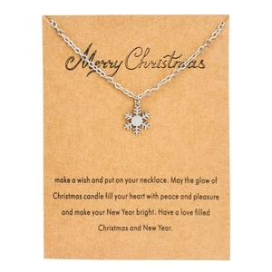 Close-up of snowflake pendant necklace on a brown kraft card for Christmas gift