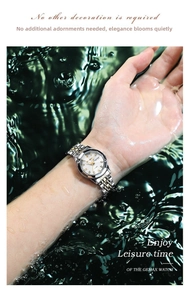 Close-up of waterproof ladies watch with luminous dial splashed in dynamic water