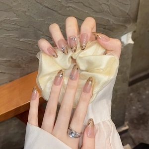 Handmade almond press-on nails with leopard print, gold glitter, and rhinestone accents