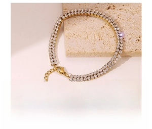 Detail of double-row cubic zirconia bracelet in gold titanium steel with lobster clasp