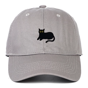 Close-up of grey cotton baseball cap featuring detailed black cat embroidery with yellow eyes