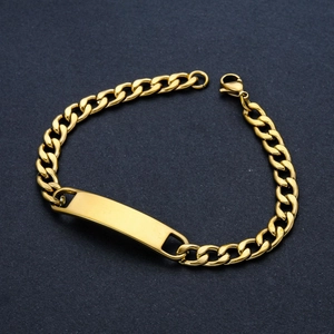 Detail of golden stainless steel Cuban link bracelet with a blank rectangular ID plate