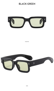 Detail of square black frame sunglasses with light green lenses and arrow accents