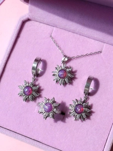 Close-up of sunflower jewelry set with purple opal stones in a velvet gift box