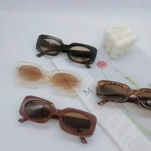 Retro small square frame sunglasses displayed on a magazine in various stylish colors