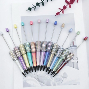 Colorful DIY beaded pens with sparkling rhinestone accents and metallic top rods