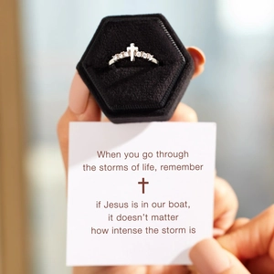Silver cross ring with white zircon stones presented in a black velvet jewelry gift box