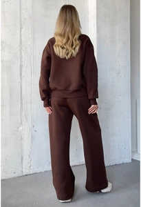Detail of dark brown knitted lounge set showing loose fit sweatpants from a back view