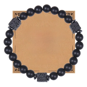Detail of matte black lava stone bead bracelet on a 'To My Grandpa' kraft gift card