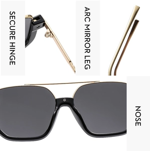 Detail view of reinforced hinges and curved legs on black fashion sunglasses with gold trim
