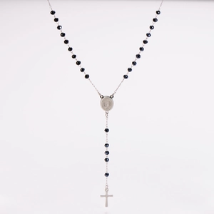 Detail of silver rosary necklace with black beads, Virgin Mary medal and cross pendant