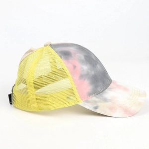 Detail of tie-dye ponytail baseball cap featuring breathable mesh and pink yellow pattern