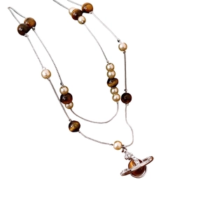 Double-layer silver necklace with brown tiger eye beads, pearls, and crystal planet pendant