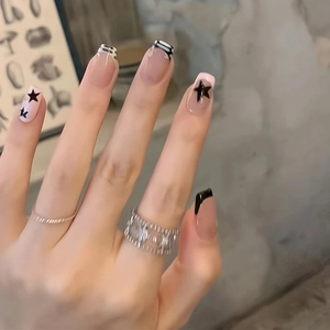 French tip press-on nails with black stars and stripes on natural nude base