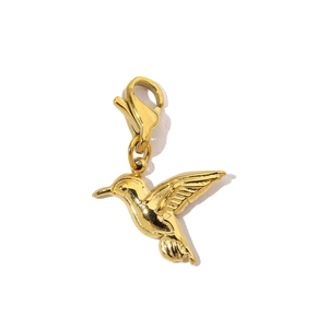 Detailed view of hummingbird pendant charm in gold finish with lobster clasp attachment