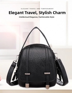 Close-up of black litchi grain texture and metal buckles on a vintage shoulder bag