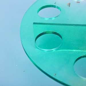 Close-up of translucent mint green epoxy resin display stand with sparkling gold glitter