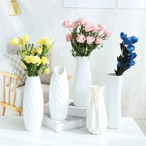 Selection of white ceramic vases with ribbed and diamond textures for home decor
