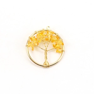 Macro detail of Tree of Life pendant with gold wire wrap and yellow crystal stones