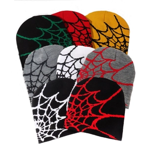 Detail showing various color options of knitted beanies with all-over spider web patterns