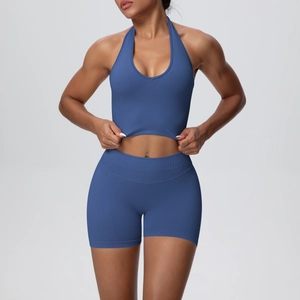 Detail of high-stretch blue ribbed knit yoga set featuring halter neck top and biker shorts