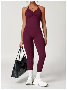 Detail of burgundy ruched V-neck yoga top and high-waisted seamless leggings