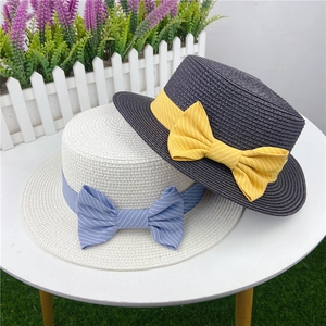 Flat top straw sun hats with elegant striped bow ribbons in white and dark grey colors