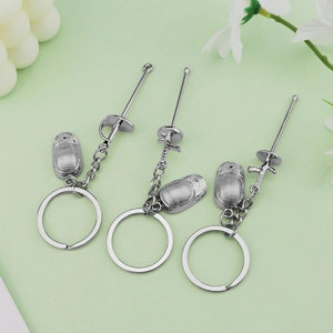 Fencing sport keychains with miniature sabre, foil, epee swords and masks in silver metal