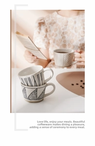 Detailed close-up of hand-painted ceramic coffee mugs with artistic black geometric patterns