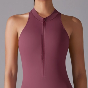 Macro view of burgundy workout bodysuit with front zipper closure and stand-up collar