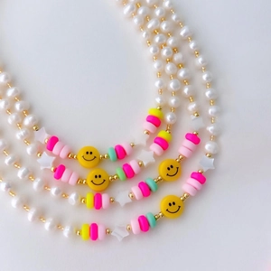 Handmade freshwater pearl necklace with yellow smiley faces and colorful star beads