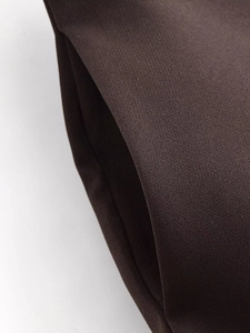Detail view of high-density twill fabric and the side pocket of the dark brown blazer set
