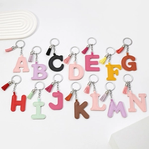 Colorful PU leather alphabet keychain letters A to N with fringe tassels on white background