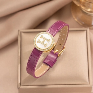 Purple leather bracelet with golden H logo and white shell inlay on jewelry box