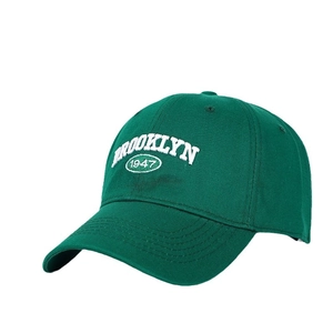Deep green baseball cap with Brooklyn 1947 embroidery and a curved brim for sun protection