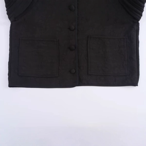 Women's black quilted jacket featuring floral embroidery patterns and square front pockets