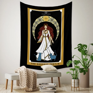 Detail of Freyja Goddess Tarot tapestry hung above a cozy armchair with green plants