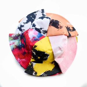 Radial layout of colorful tie-dye bucket hats in various artistic splatter patterns