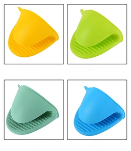 Detail showing colorful silicone oven mitts with non-slip ridges for heat protection