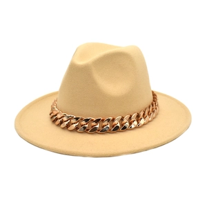 Detail of wool fedora hat with elegant wide brim and chunky rose gold metal chain
