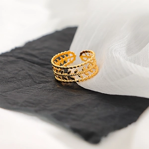 Macro shot of 18k gold plated stainless steel ring with elegant hollow olive leaf pattern