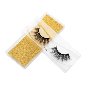 Detail of 3D faux mink eyelashes style #104 with thick curls on gold glitter base