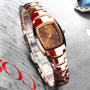 Detail view of the rose gold chain strap and tonneau brown dial on the quartz watch