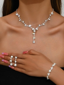Exquisite silver-tone bridal jewelry set with sparkling crystals worn by a model