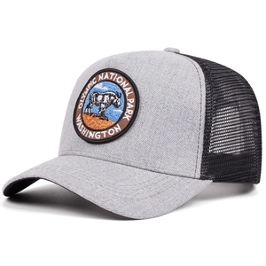 Close-up of Olympic National Park embroidered patch on a gray and black mesh trucker hat