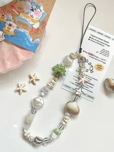 Detail of ocean-themed handmade beaded wrist strap with starfish, shells and pearls