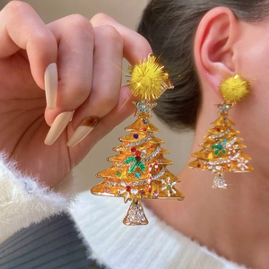 Detail of Christmas tree earrings with colorful rhinestones and a yellow pom-pom top