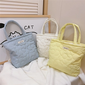Detailed flower quilted tote bags in blue, cream, and yellow with soft down cotton texture